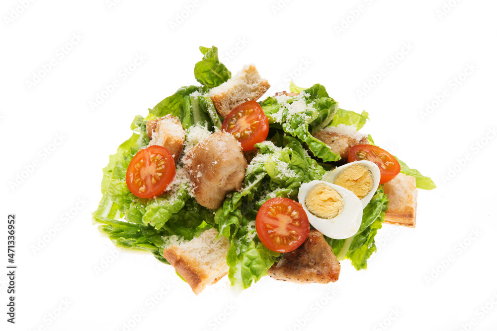 Caesar salad with chicken, croutons and parmesan isolated on a white background Caesar salad with chicken, croutons and parmesan isolated on a white background