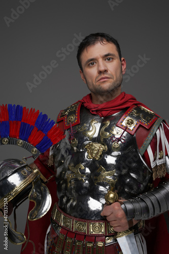 Fototapeta Powerful roman centurion with plumed helmet isolated on gray
