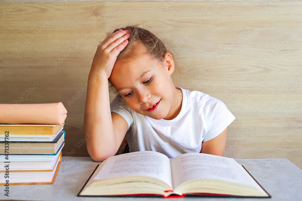 Schoolgirl girl reads books after school to know a lot Schoolgirl girl reads books after school to know a lot