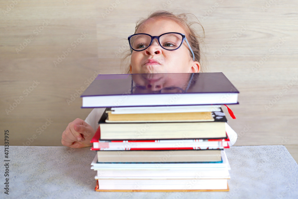Schoolgirl girl reads books after school to know a lot Schoolgirl girl reads books after school to know a lot