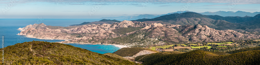 Panoramic view over Ostriconi beach and the turquoise Mediterranean sea in the Balagne region of Corsica with the Desert des Agriates in the distance