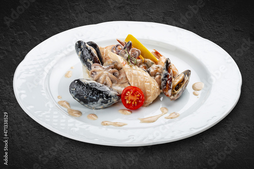 Rice with seafood: shrimp, squid and mussels. Isolated on a black background.