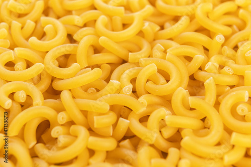 Dry yellow gobetti pasta. Carbohydrate wheat vegetarian food