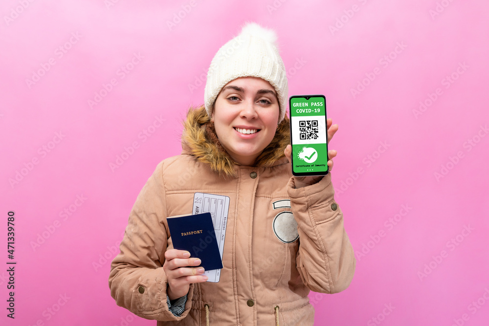 Caucasian woman ready to travel with passport, tickets and green pass. New immunity covid-19 health passport.