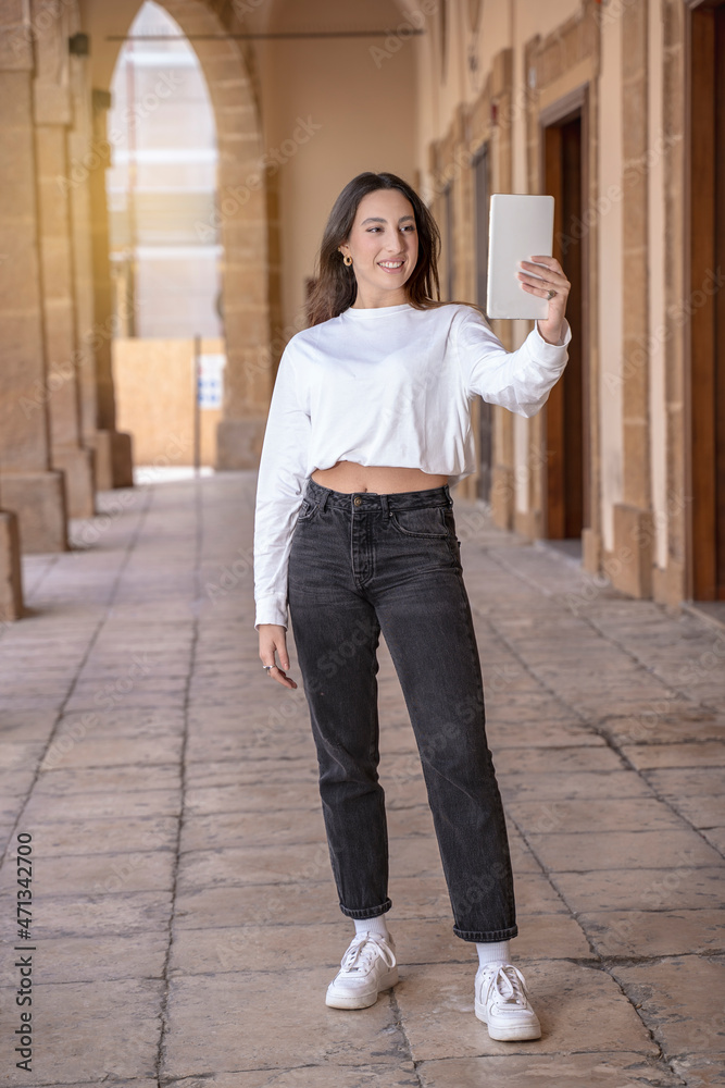 young beautiful brown hair sicilian woman lifestyle using tablet outdoor young beautiful brown hair sicilian woman lifestyle using tablet outdoor