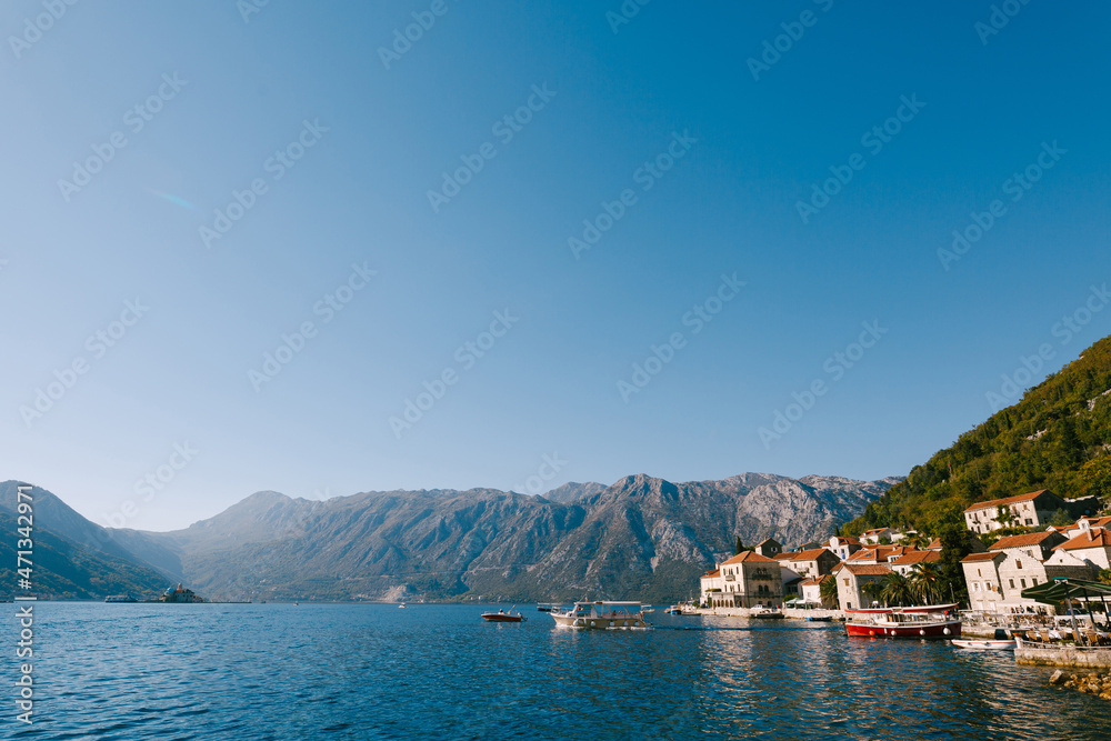 Bright blue sky over the mountains and the coast of Perast. Montenegro