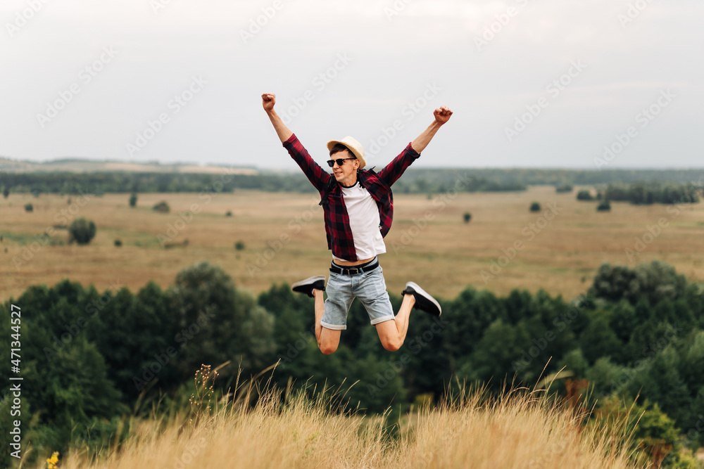 free man standing alone with raised arms during a beautiful sunrise in the morning. Togetherness with nature free man standing alone with raised arms during a beautiful sunrise in the morning. Togetherness with nature