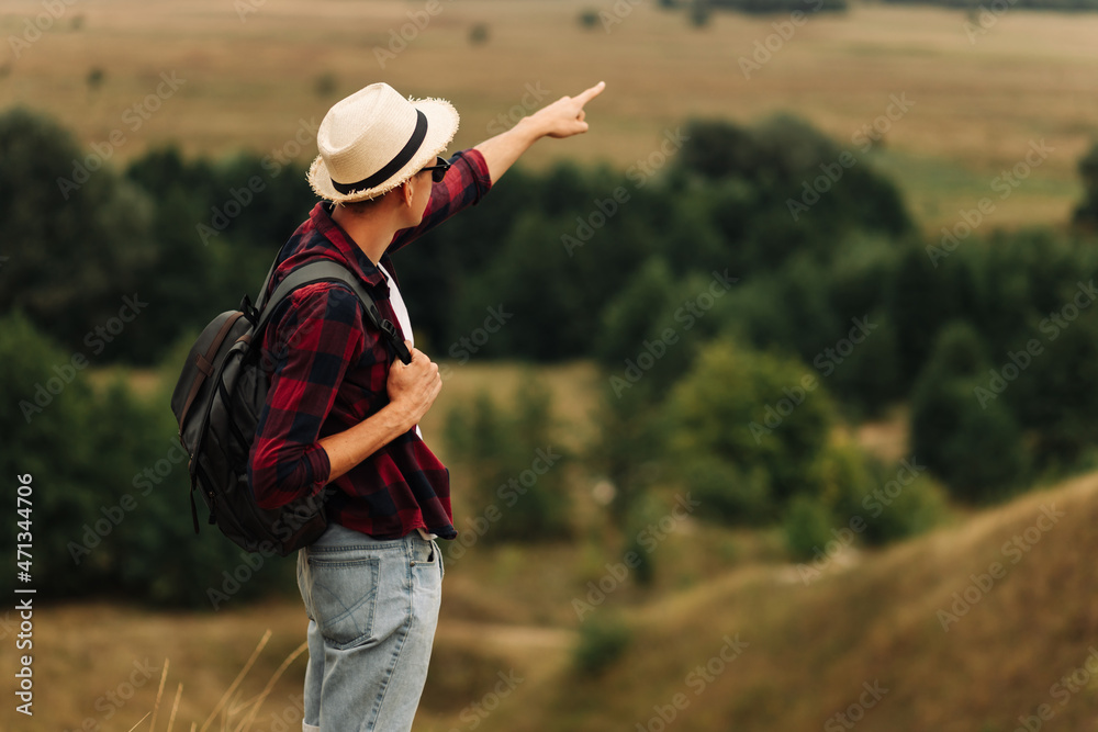custom made wallpaper toronto digitalman with a backpack on a country walk on a summer day. Young people hiking in the countryside, outdoors at sunset