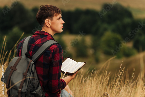 Print op canvas Reading the Bible outdoors in nature
