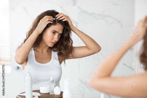 Frustrated Lady Searching Hair Flakes Suffering From Dandruff Problem Indoors photo