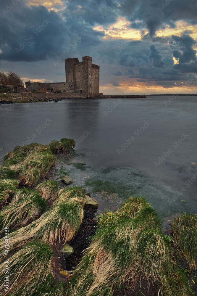 Dramatic cloudy sunset scenery of Oranmore Castle on the rocky coast of Wild atlantic way in county Galway, Ireland Dramatic cloudy sunset scenery of Oranmore Castle on the rocky coast of Wild atlantic way in county Galway, Ireland