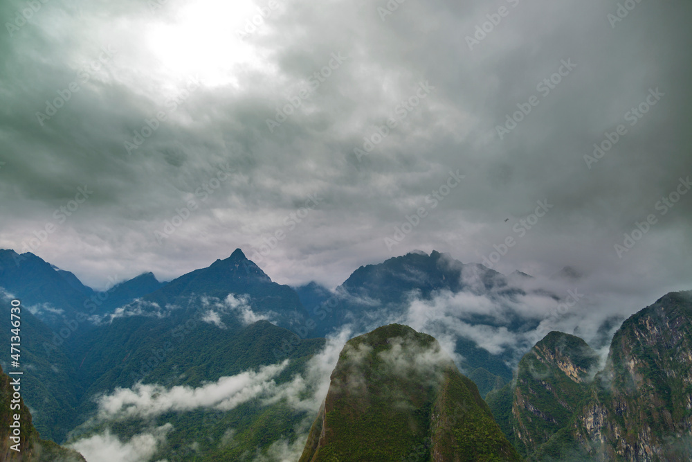View of green mountains surrounding Machu Picchu with cloudy sky. View of green mountains surrounding Machu Picchu with cloudy sky.