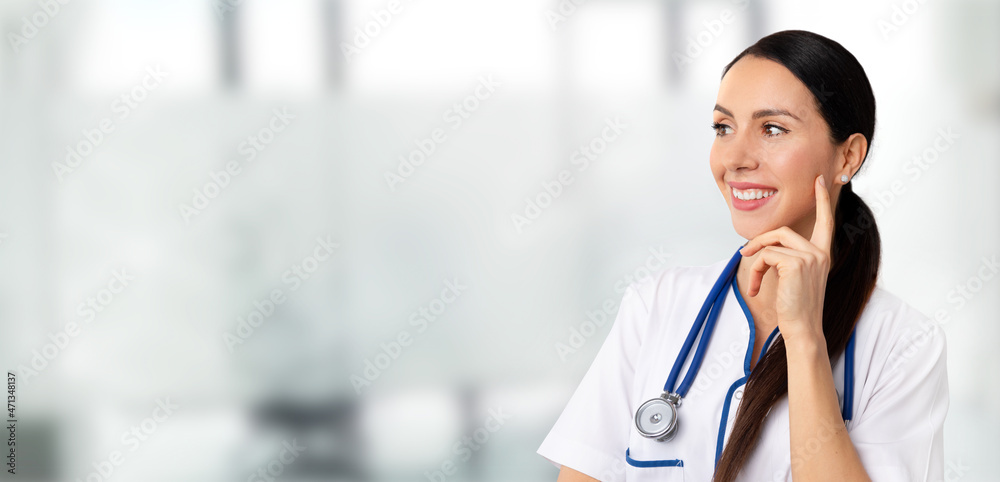 Beautiful woman doctor on medical background