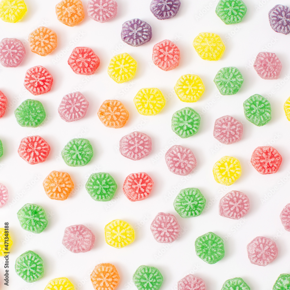 Delicious candy pattern. Sugar candies in red, green, yellow, orange and purple. A modern concept of sweets.
