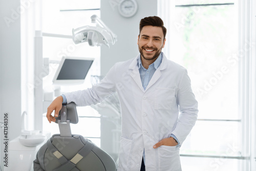 Handsome caucasian man doctor posing at newest dental clinic