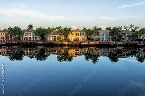 Hollywood beach in north Miami, Florida with Intracoastal water canal Stranahan river and view of waterfront property modern mansions villas houses with palm trees reflection at sunset photo