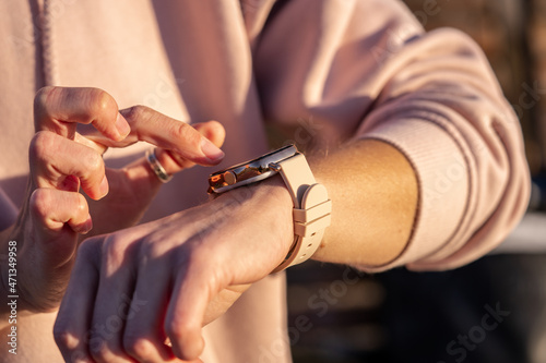 Woman hands in smart watch walking outdoors, step counting, fitness tracker, close up, copy space