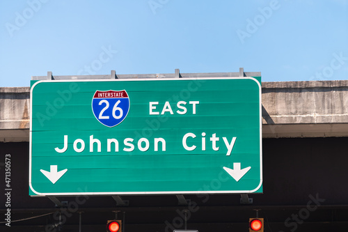 Johnson City, USA road street interstate highway green sign for i26 26 east to Johnson City in Tennessee with text isolated closeup and blue sky