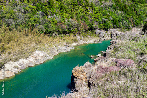 Emerald blue and green turquoise colorful Hida river high angle aerial view perspective in spring springtime near Gero Onsen town in Gifu prefecture in Japan photo