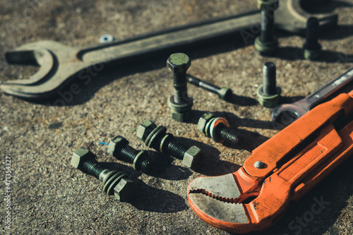 Screws, bolts and fasteners, wrench on an industrial background.