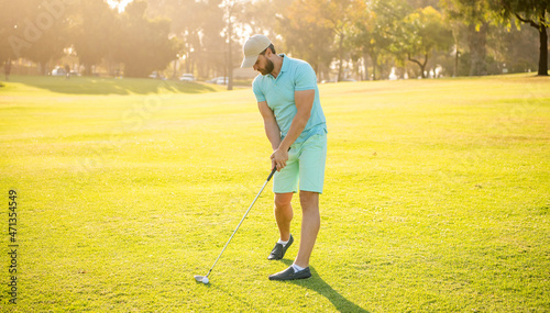 golfer in cap with golf club. people lifestyle. sport man playing game on green grass.