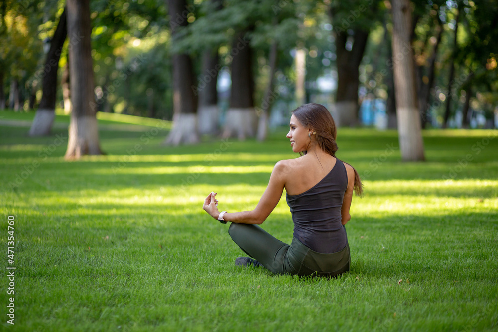 beautiful young girl meditaiting in the park beautiful young girl meditaiting in the park