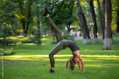 beautiful young girl exercising in the park, yoga, relax fitness