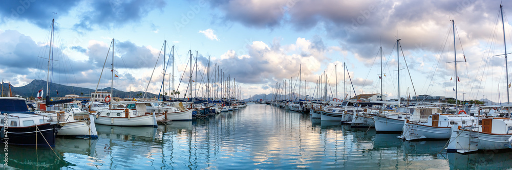 Port de Pollenca marina with sailing boats sailboats on Mallorca travel traveling holidays vacation panorama in Spain