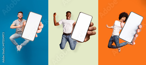Satisfied happy excited diverse people jumping, have fun and show smartphone with blank screen