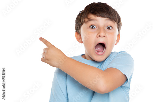 Child kid amazed surprised little boy pointing on ad advertising isolated on white photo