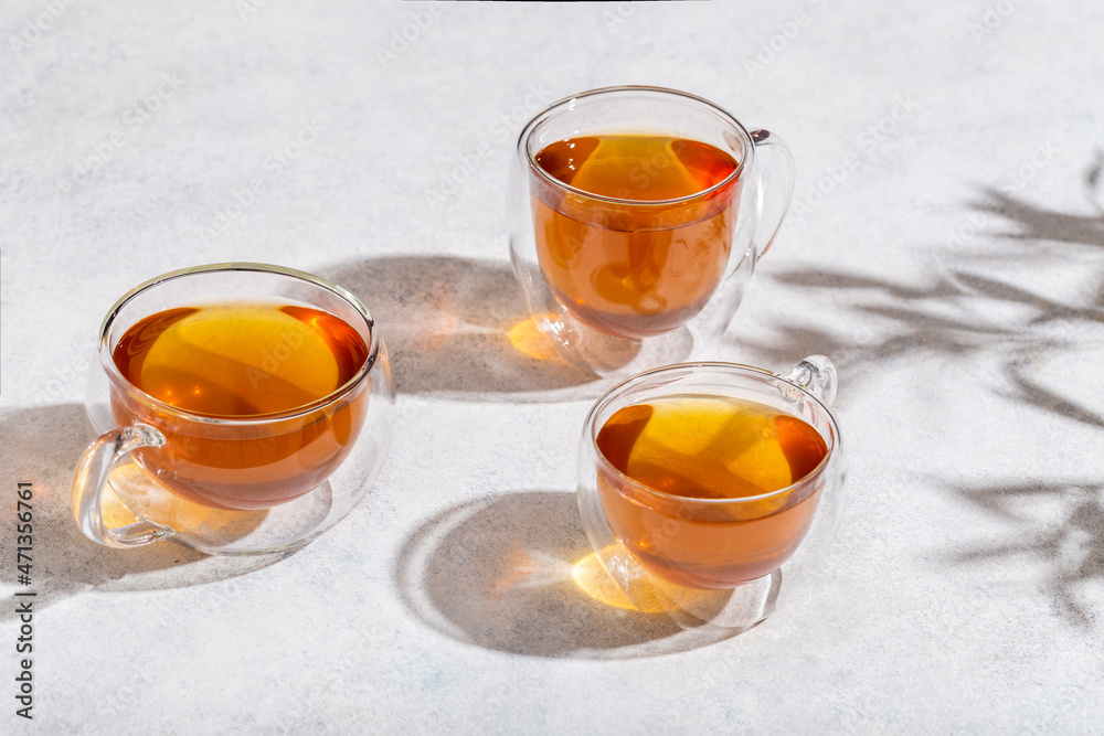 glass cups of tea on lightn table glass cups of tea on lightn table