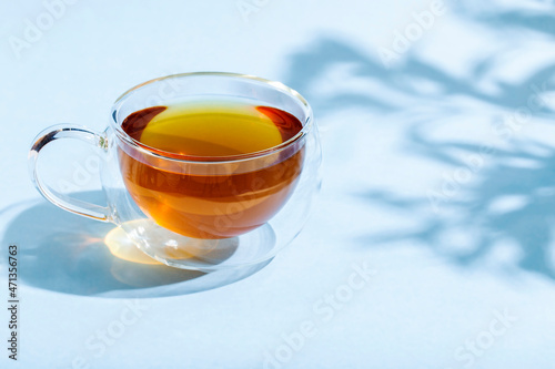 glas cup of tea on lightn table
