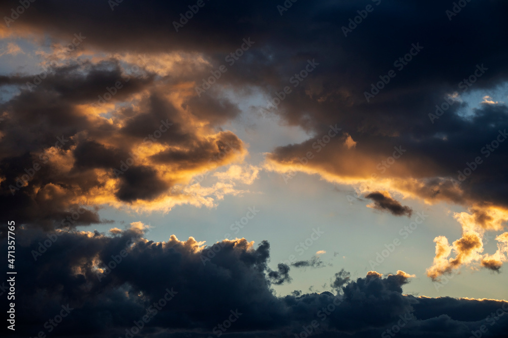 Dramatic cloudscape at sunset. Sunset with sun rays. Evening sky with dramatic clouds view. Gradient color. Sky texture, abstract nature background