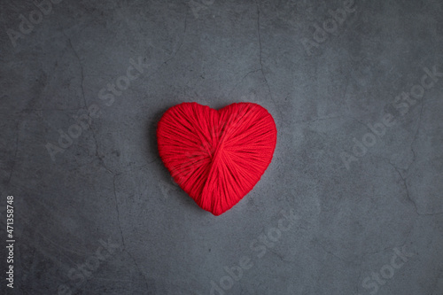 Heart for Valentine s Day made of red wool threads on a dark background. Space for text. Concept holidays  love.