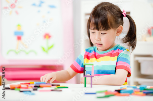young girl play number sticks fine motor skill game for homeschooling