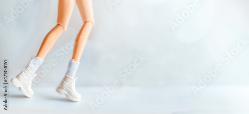 Physical activity and health. Doll's legs in white sneakers depicting running or movement