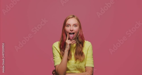 Funny humorous young girl grimacing, fooling around show tongue, comical goofy facial expression, laughing