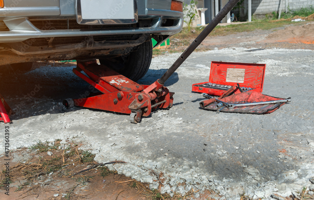 Extra safety measures are taken by using a hydraulic jack and jack stand to lift up a vehicle. Extra safety measures are taken by using a hydraulic jack and jack stand to lift up a vehicle.