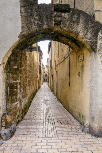Pedestrian alleyway in the medieval city of Sommi  res in the south of France