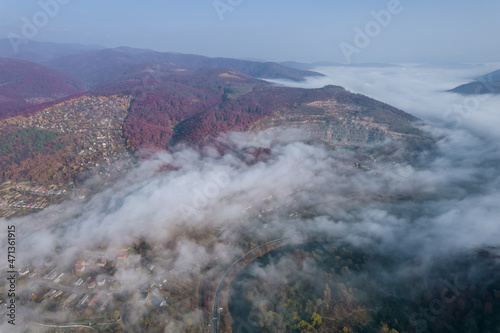 Thick morning fog over the village in the mountains. Fog in the mountains on an autumn day. © Yaroslav