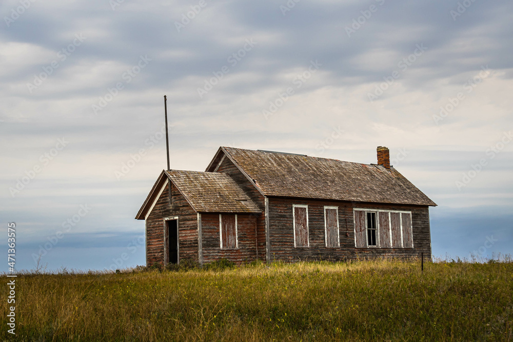 An old abandoned one room school house on the prairie of North Dakota in the evening. An old abandoned one room school house on the prairie of North Dakota in the evening.