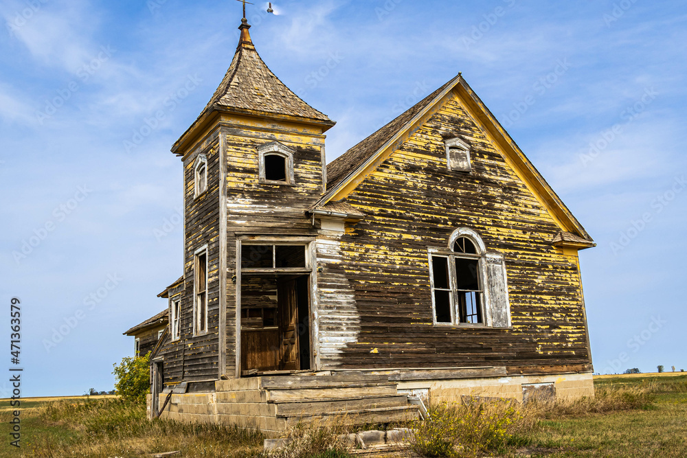 An old abandoned church on the prairie of North Dakota in the evening.