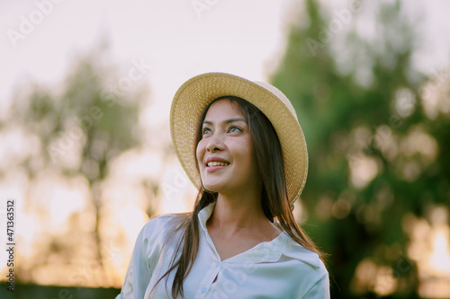 Photography headshot of beautiful woman wearing straw hat and toothy smiling with happiness