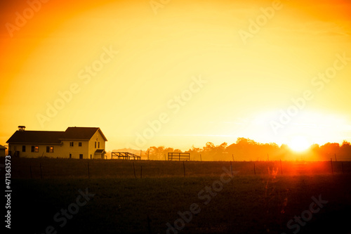 I farmhouse and field at sunrise with a slight morning mist in Indiana Fototapet
