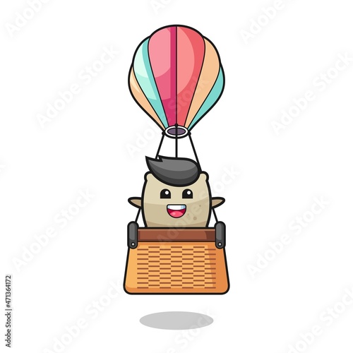 sack mascot riding a hot air balloon