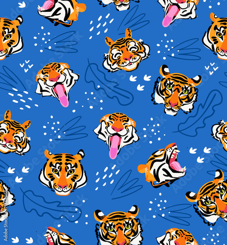 Tiger head vector seamless pattern on blue background. Funny flat vector illustration. Modern background design.