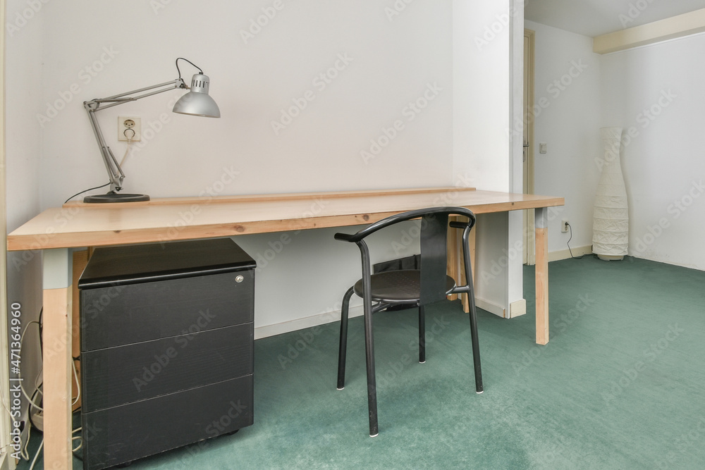 Wooden table with lamp in room Wooden table with lamp in room