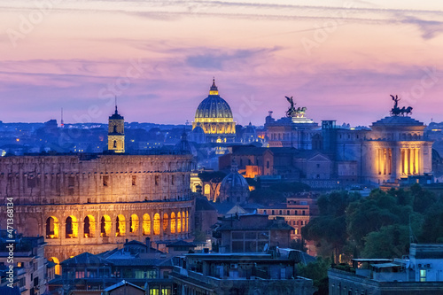 Night view at Coliseum, Fatherland altar and St. Peter's cathedral in Rome with red sunset