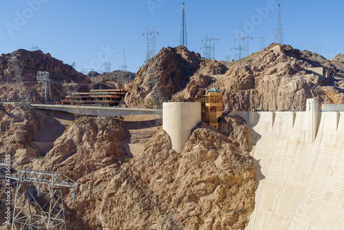 A view of Hoover Dam taken on November of 2021 showing a multituted of power lines and towers, and other infrasctructure.