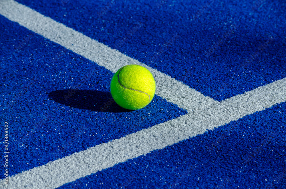 Ball next to the lines on a paddle tennis court